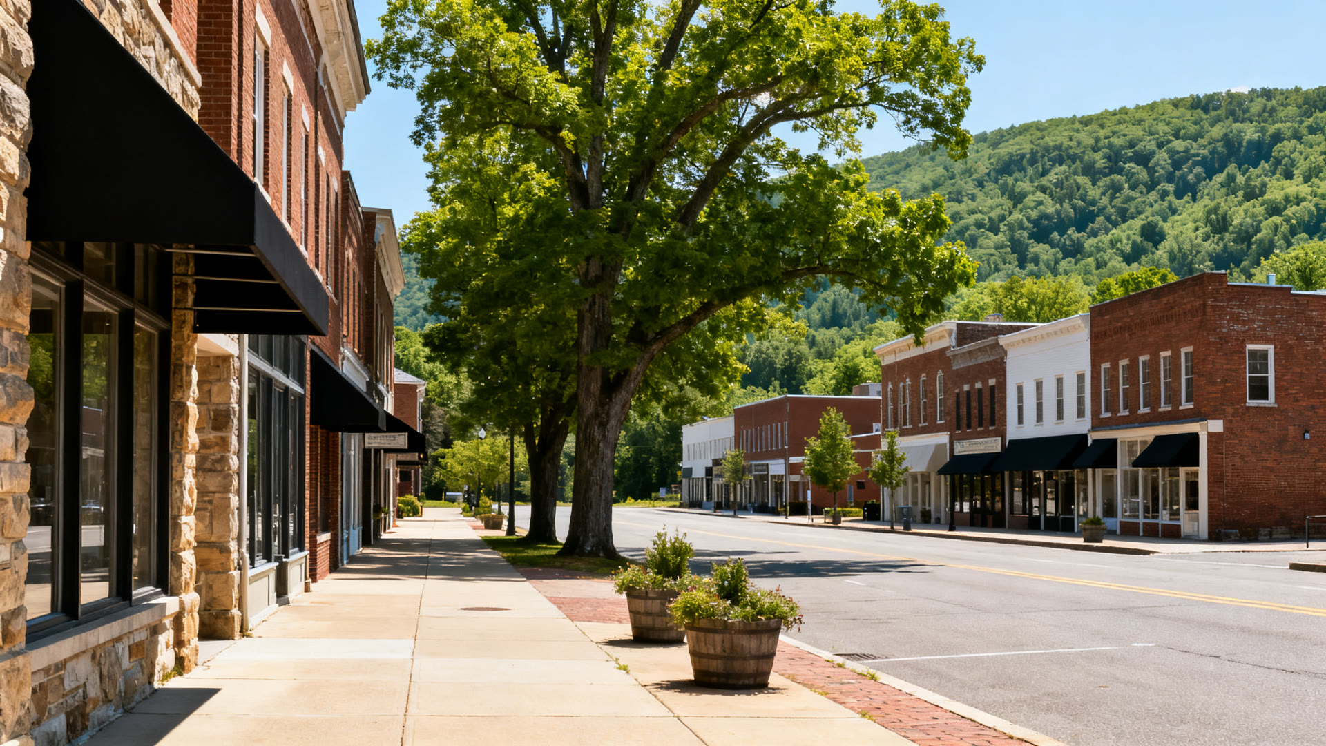A college town street of brick and stone shopfronts on a clear summer day
