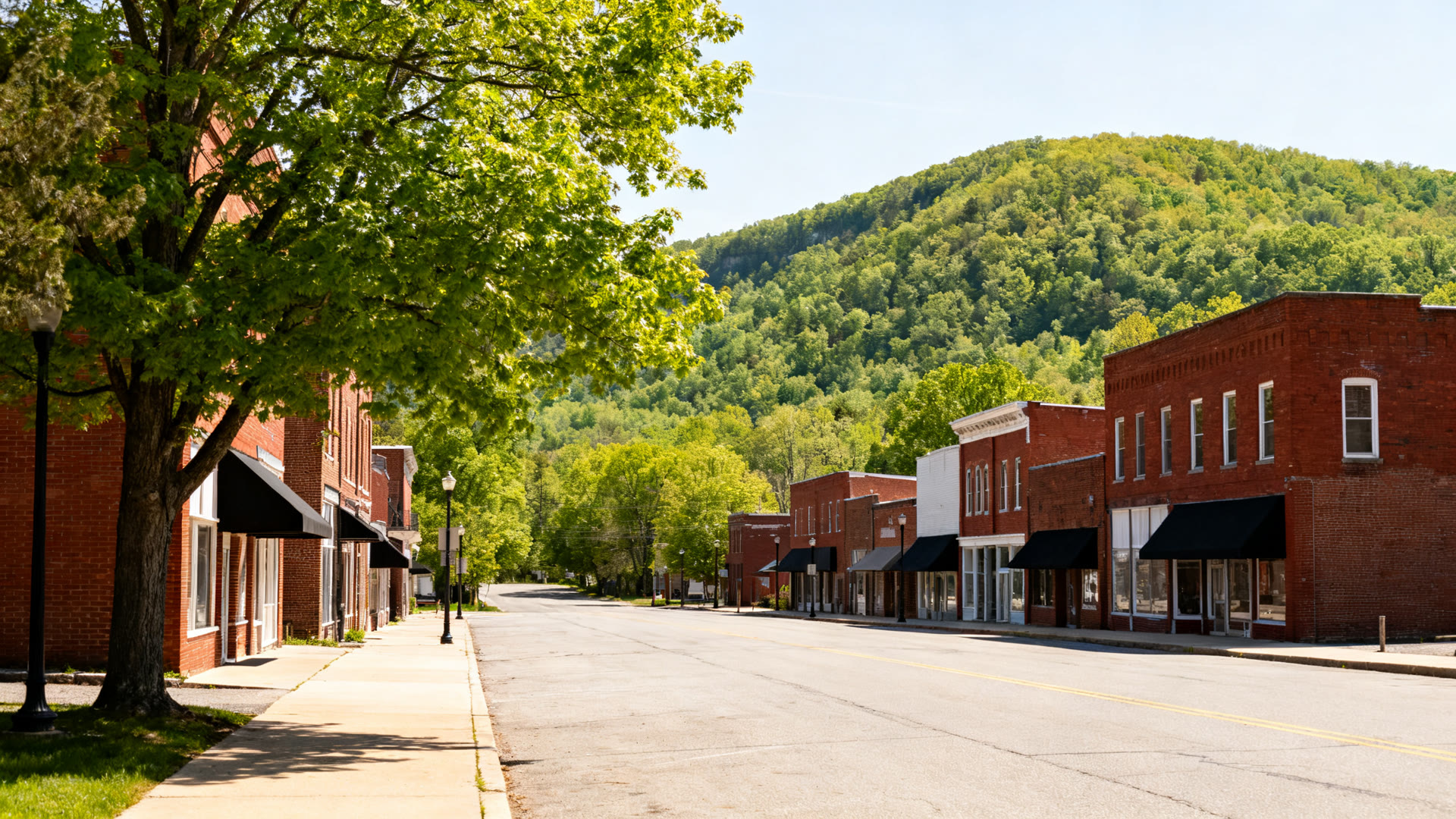 A central Pennsylvania main street of brick storefronts on a summer morning